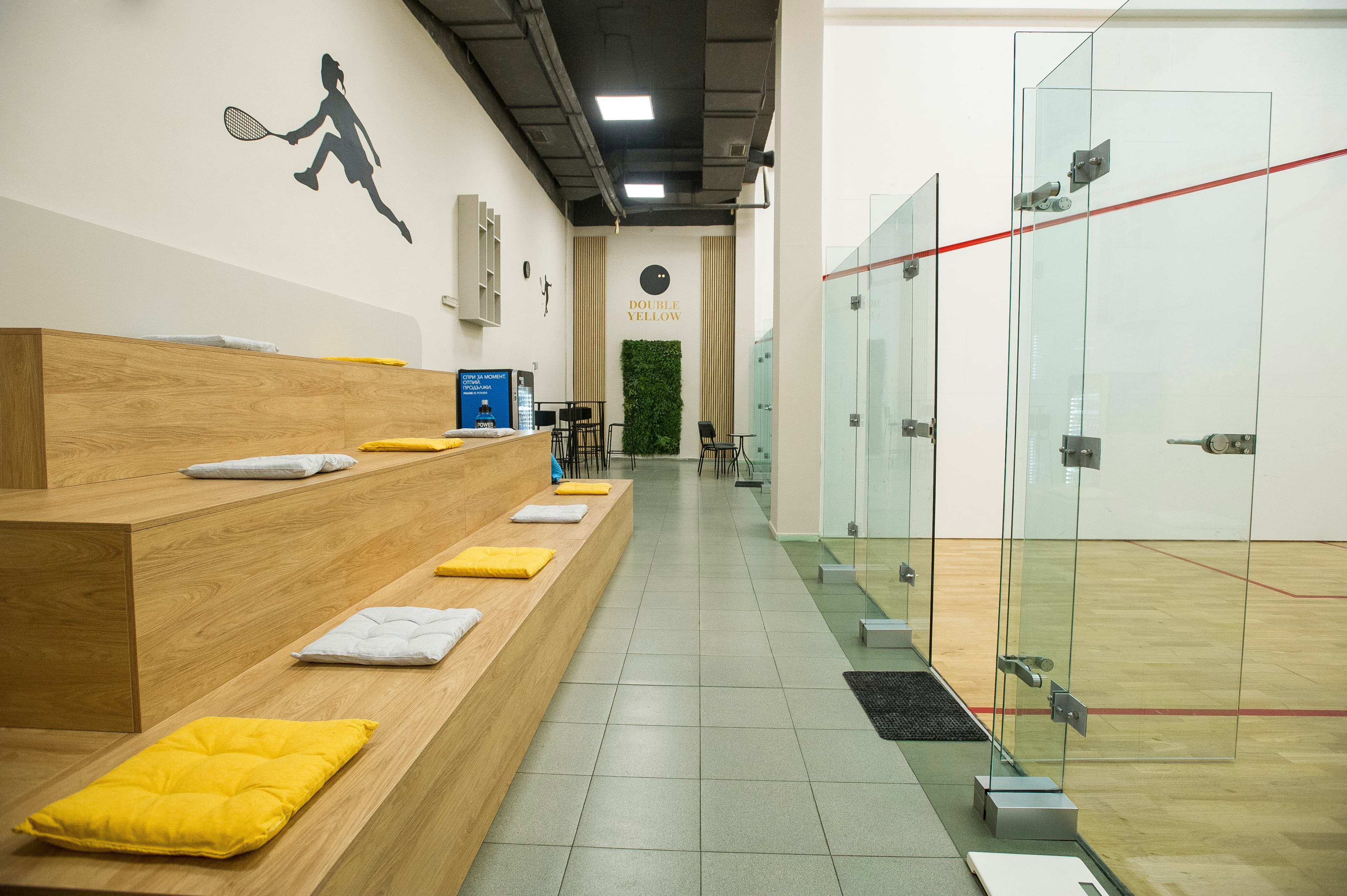 Multiple squash courts with modern lighting and equipment